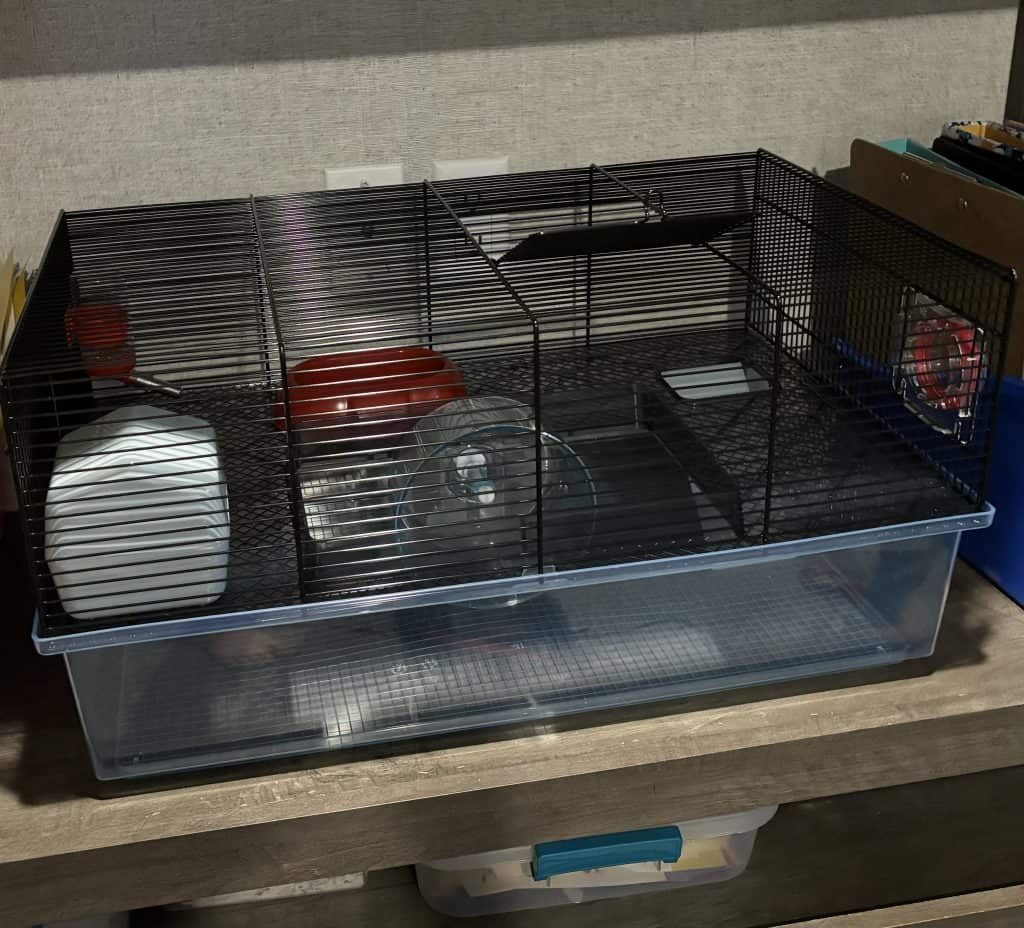A two-story mouse cage with several amenities.